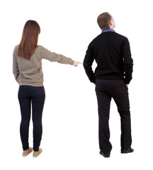 Back view of couple in sweater with mobile phone.