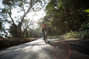 Fototapeta premium Woman cycling on bike path at park on sunny day