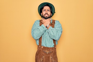 Young handsome man wearing tratidional german octoberfest custome for Germany festival shouting...