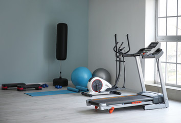 Fototapeta na wymiar Interior of gym with modern equipment