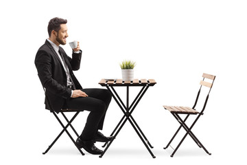Businessman sitting at a cafe and drinking espresso coffee