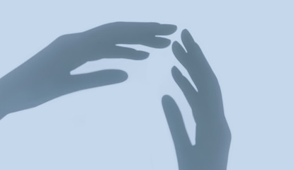 Two hands shadow on light blue background. Connecting and contact. Helping. Relationship. Copy space