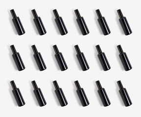 Obraz premium The black glass natural cosmetic or parfum spray bottles on white background. Face, body skin or hair care. Health and beauty. Spa and cosmetology