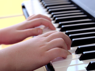 Closeup girl hands playing piano