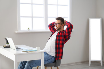 Young man with laptop working at home