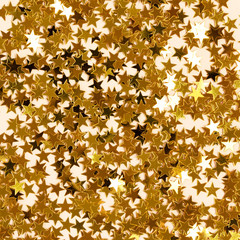 Golden stars confetti texture. Glowing background.