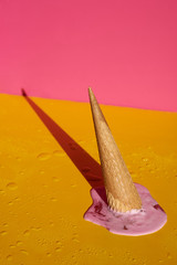 Strawberry ice cream cone upside down and melted.