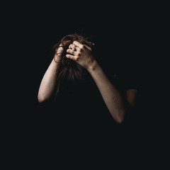 arms that sprout from the black of the shadows that rest on the head in desperation