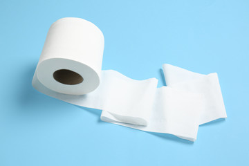 Roll of toilet paper on color background