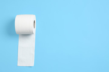 Roll of toilet paper on color background
