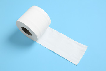 Roll of toilet paper on color background