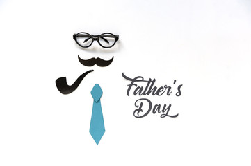Fathers Day greeting card design for men's event, banner or poster..Background with mustache, tie and  glasses. Paper cut lettering. Space for text. Soft focus. Top view.