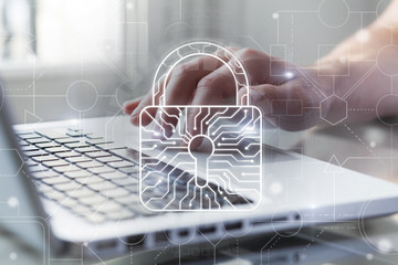 Cyber security and protection of private information and data concept. Bright big lock with integrated circuit on it. Person using computer on background. Safe payments concept.