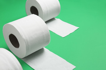 Rolls of toilet paper on color background