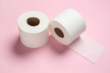 Rolls of toilet paper on color background