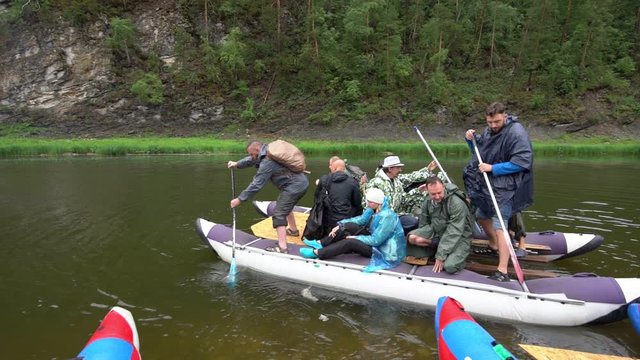 Catamaran eco tourists sailed from the coast. Alloy on the mountain river