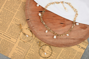 gold jewelry for women on wooden background