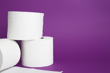 Rolls of toilet paper on color background