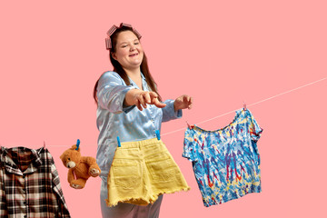 Cheerful beautiful fat girl in blue pajamas hangs clothes after washing