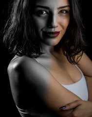 Naklejka premium Low key portrait of beautiful young woman. Colorful, black and white. Creative concept.
