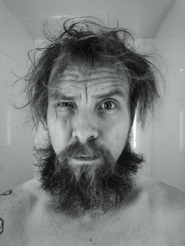 Portrait Of Shirtless Man With Tousled Hair At Bathroom