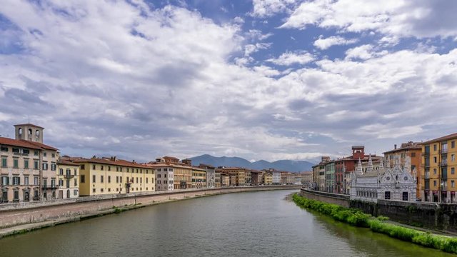Beautiful view of the Lungarni of Pisa, Italy, of the historic center with the Church of Santa Maria della Spina from the Solferino bridge. Time lapse motion
