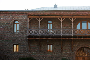 Fototapeta na wymiar Wooden balcony and windows. Part of Svetitskhoveli Orthodox Cathedral castle fence in Mtskheta