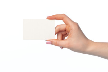 Obraz premium Female hand with blank white business card isolated on white