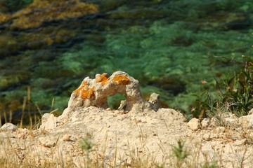 Rock hole created by nature. Closeup rock erosion holes sea wall. Wallpaper and background. External texture.