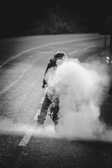 A man is doing burnout his motorcycle tire