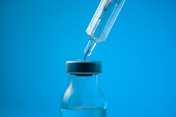 medical ampoules and syringe on white background