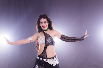 Portrait of a woman in oriental costume performing belly dance. Tribal fusion dance concept.