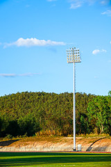 Running and football stadium sport light with blue sky background