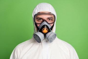 Close-up portrait of his he nice confident content professional disinfectant wearing gas mask equipment human health care wellbeing isolated over green pastel color background