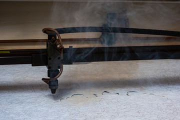 laser machine burns out stencils form on paper for the production of metal products