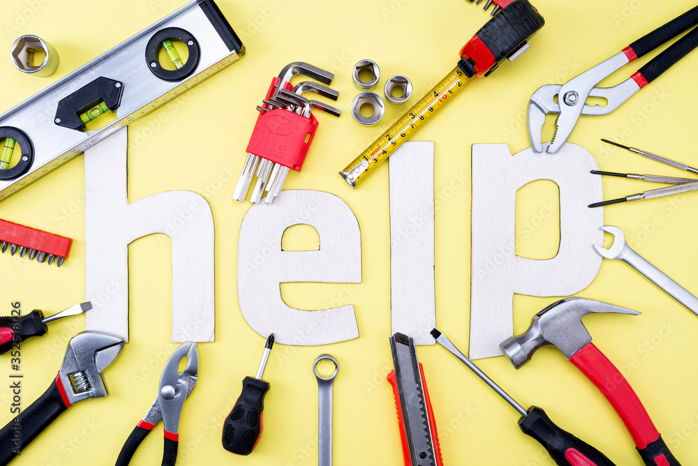 Wall mural coplet of repair tools on a yellow background and the word help made of wooden letters. equipment fo