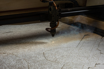 laser machine burns out stencils form on paper for the production of metal products