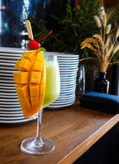 Fresh tropical fruit smoothie mango and kiwi juice on the table