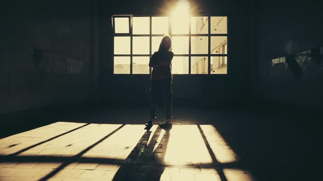 Girl alone indoors isolated. Light and shadow