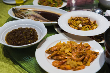 Various chinese meals on a table in a chinese restaurant