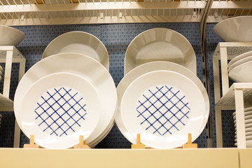 a large set of multi-colored dishes on the shelves of the supermarket. 