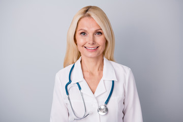 Closeup photo portrait of smart skilled old lady cardiologist with toothy smile isolated on grey...