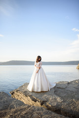 Portrait of a bride on the background of the lake.