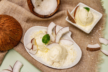 Lactose free coconut ice cream. Special spoon, halves of fruit, flakes