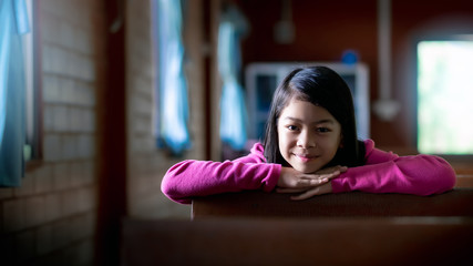 Young christian girl is happy and smile after praying in the church. Christian concept.