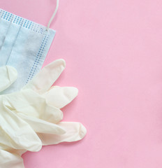 Gloves and facemask on pink background