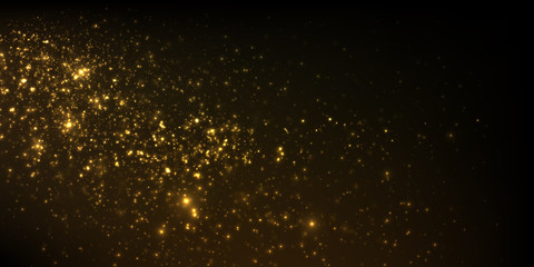 Sparkling golden particles on black background	