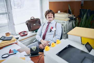 Gladsome male accountant enjoying working in his retro office