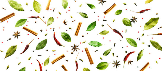 Flying spices Bay leaf, red chili pepper, anise, cinnamon sticks isolated on a white background. Long food pattern banner.