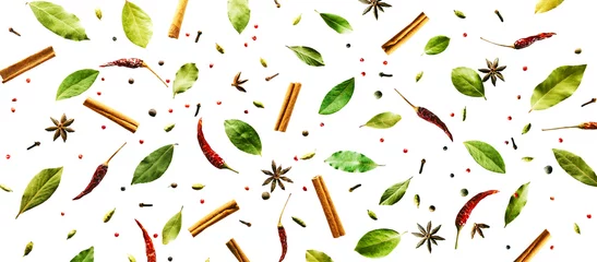 Fototapeten Flying spices Bay leaf, red chili pepper, anise, cinnamon sticks isolated on a white background. Long food pattern banner. © PINKASEVICH